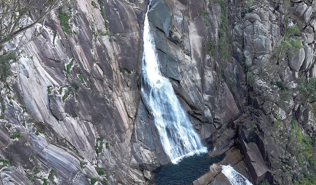 View of Dandahra Falls cascading over grey rock ledges into pools. Photo &copy; Koen Dijkstra