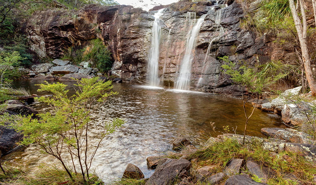 View of 2 waterfalls cascading into a rock pool  in a natural bush setting. Photo credit: Robert Cleary &copy; DPIE