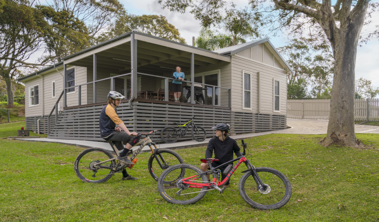 Guests on bikes in front of Baileys Cottage. Photo: John Spencer &copy; DPE