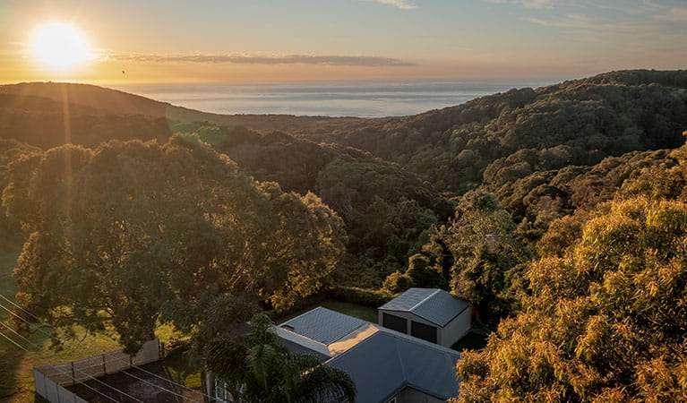 An aerial view of the ocean and Baileys Cottage in Glenrock State Conservation Area. Photo: John Spencer &copy; DPIE
