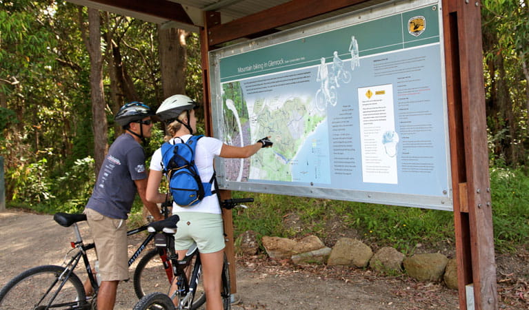 Cyclists looking at a park map. Photo: Shaun Sursok