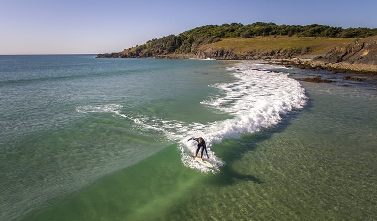 A man surfing a wave back to the shore at Goolawah National Park. Photo: John Spencer/OEH