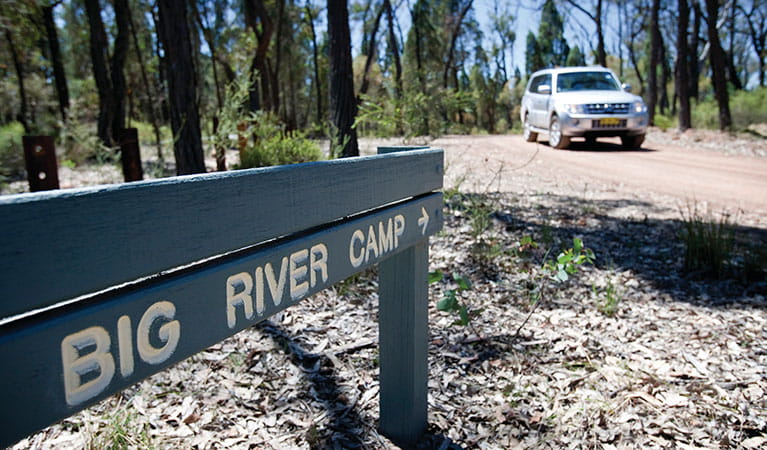 A sign towards Big River campground with a car in the background in Goulburn River National Park. Photo: Nick Cubbin &copy; DPIE