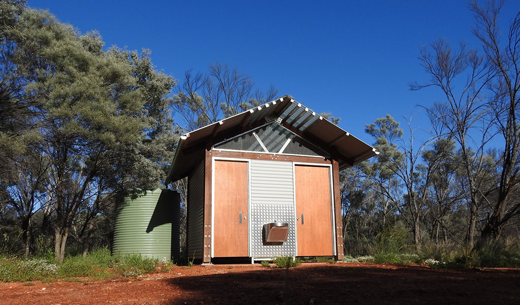 Photo of the toilet shelter and sink surrounded by trees at Dry Tank campground and picnic area in Gundabooka National Park. Photo credit: Jess Ellis/DPE &copy; DPE