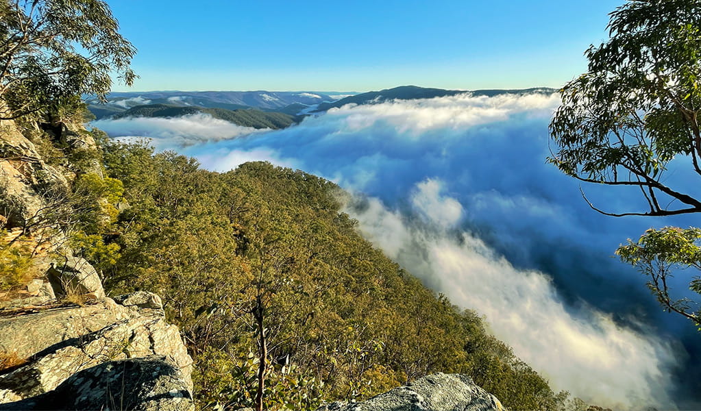 View past rocky outcrops to mountains and cloud-filled valleys. Photo &copy; Tina Sullivan