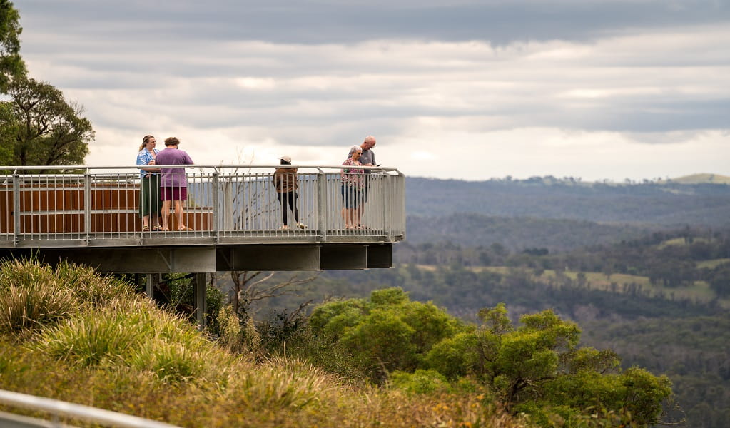 Visitors absorbing panoramic views from the cantilevered lookout at Upper Falls. Photo: David Waugh &copy; DCCEEW