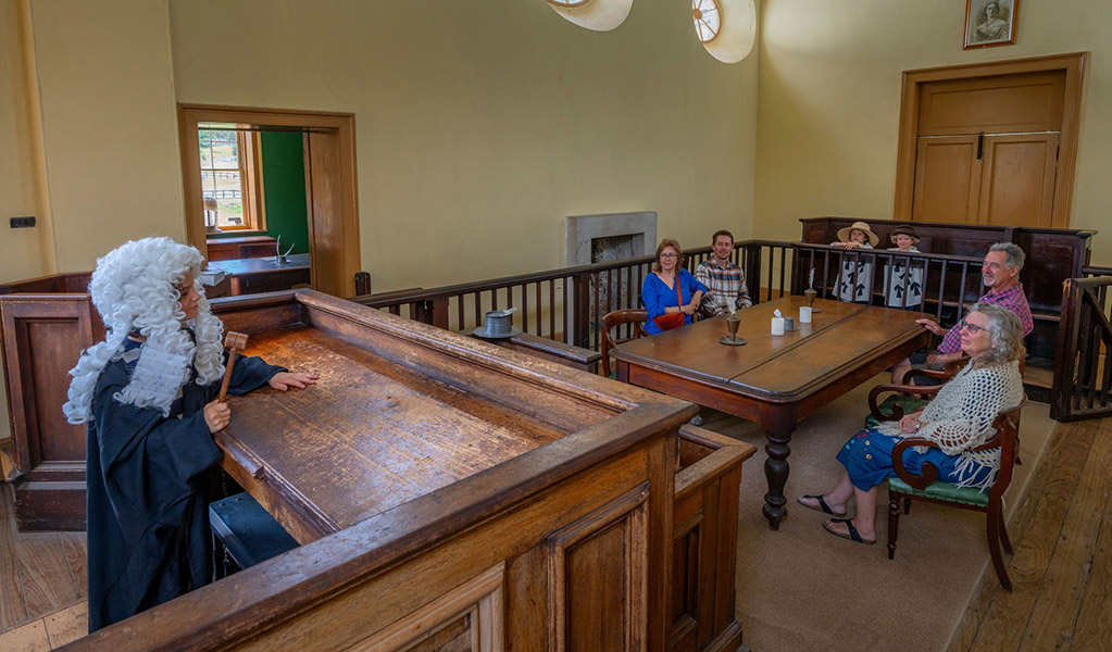 A child dressed as a judge on the judges bench pretending to address visitors inside Hartley Courthouse.  Credit: John Spencer &copy; DCCEEW