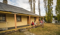 Family on the porch at Old Trahlee. Photo: John Spencer/OEH