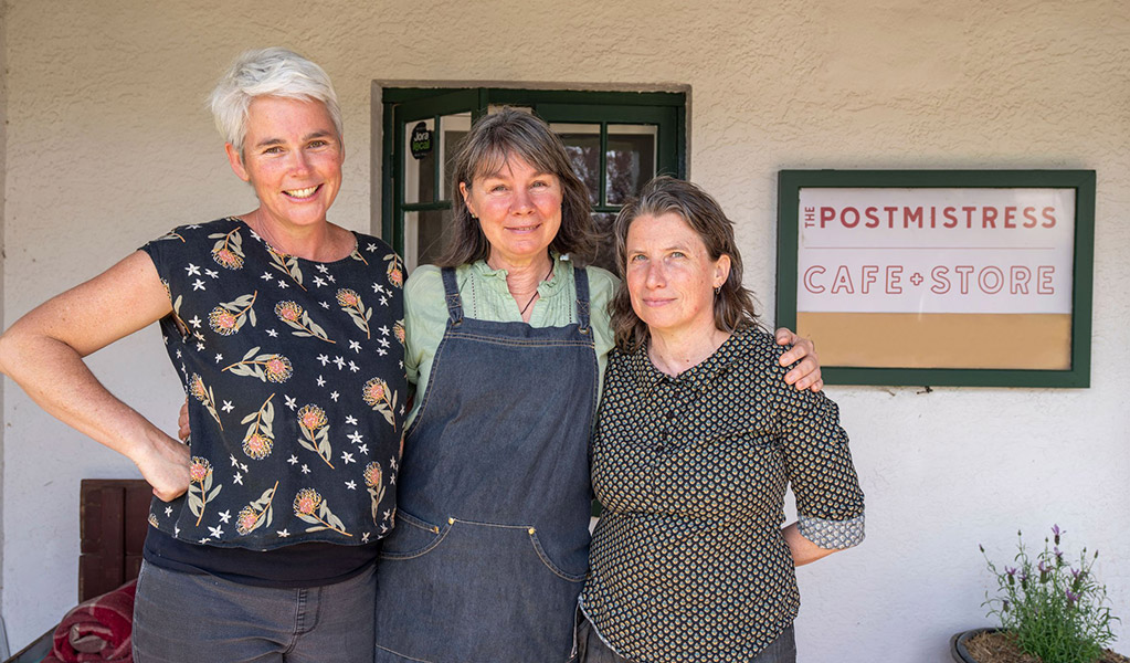Cafe staff posing for a picture outside The Postmistress Cafe and Store at Hartley Historic Site. Credit: John Spencer &copy; DCCEEW