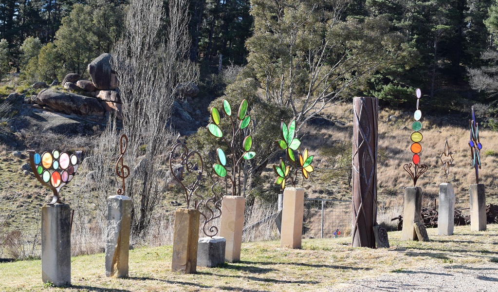 The colourful sculpture works of the Talisman Gallery overlooking the Kew-Y-Ahn granite tor at Hartley Historic Site. Photo: Asha Constance &copy; DCCEEW