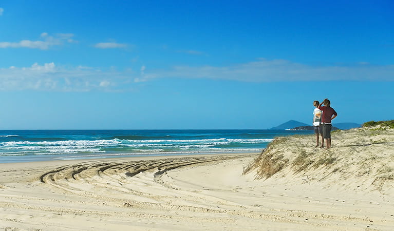 2 people on the beach at Smoky Cape campground in Hat Head National Park. Photo: Debby McGerty/DPIE