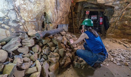 Visitor explores the original 1870s mine shaft of Bald Hill tourist mine, Hill End Historic Site. Photo: John Spencer/DCCEEW © DCCEEW
