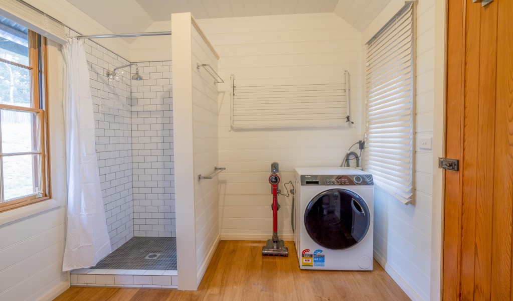 The external bathroom with shower and washing machine in Fairfax House, Hill End Historic Site. Photo: John Spencer &copy; DPE