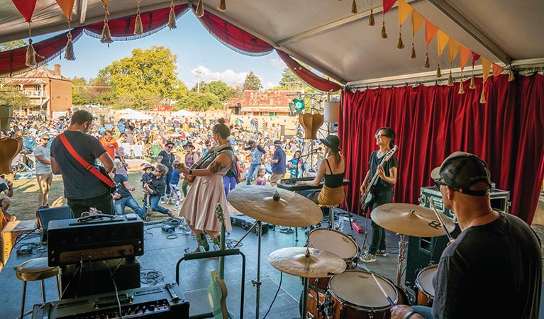 A band performing on stage in front of a crowd at The End Festival in Hill End Historic Site. Photo: John Spencer/OEH