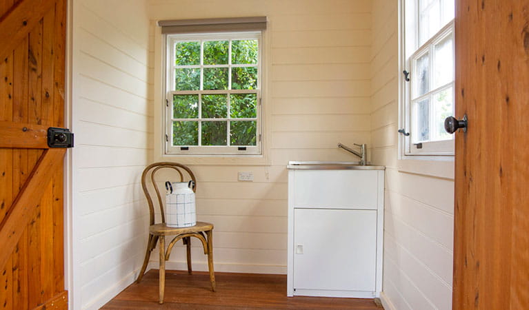 The laundry at Sydney Hotel Cottage with washtub and chair in Hill End Historic Site. Photo: Steve Garland &copy; DPIE