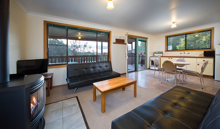 Family room with stove and kitchen area at Binda Bush cabins, Jenolan Karst Conservation Reserve. Photo: Keith Maxwell, A Shot Above Photography