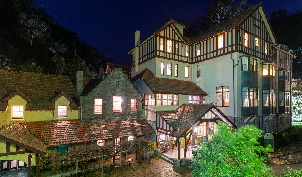 Exterior shot of Jenolan Caves House lit up at night, Jenolan Karst Conservation Reserve. Photo: Jenolan Caves/DPE