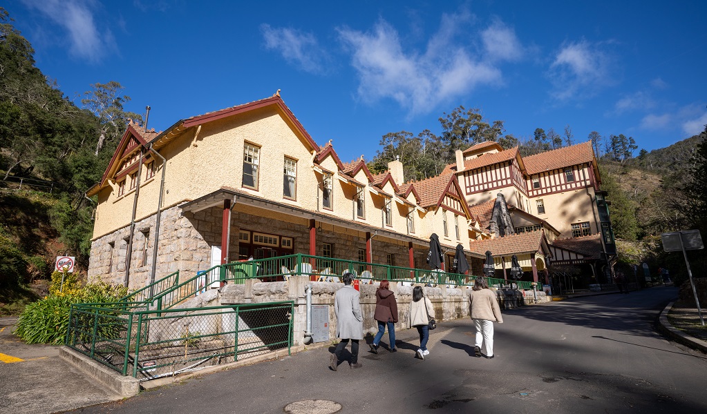 Visitors walk past Jenolan Caves House, Jenolan Karst Conservation Reserve. Photo: Jenolan Caves &copy; DPE