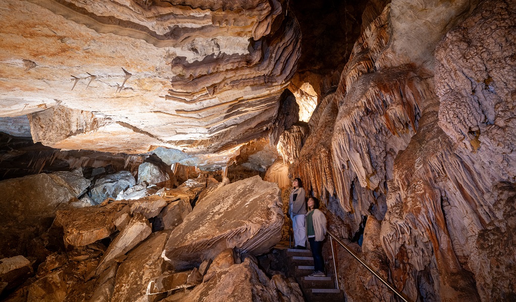 Two visitors exploring the caves at Jenolan. Photo: Jenolan Caves &copy; DPE