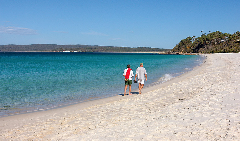 Two men walk along Hyams Beach, Jervis Bay National Park. Photo: Michael Van Ewijk &copy; DPIE