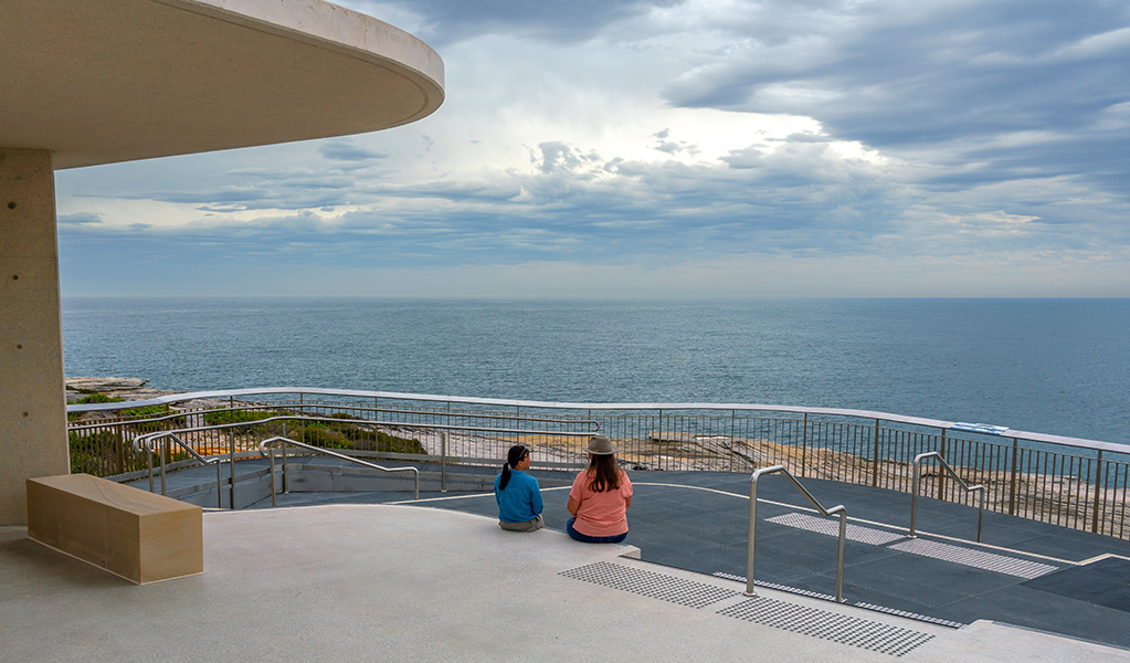 People looking out over the ocean from the whale watching platform at Cape Solander. Photo: John Spencer &copy; DPE