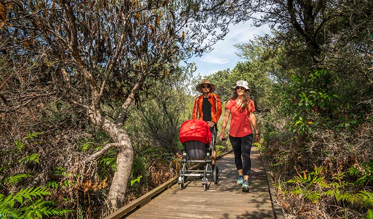 People walking and pushing their pram along the Jennifer Street boardwalk, La Perouse area, Kamay Botany Bay National Park. Photo: John Spencer &copy; OEH