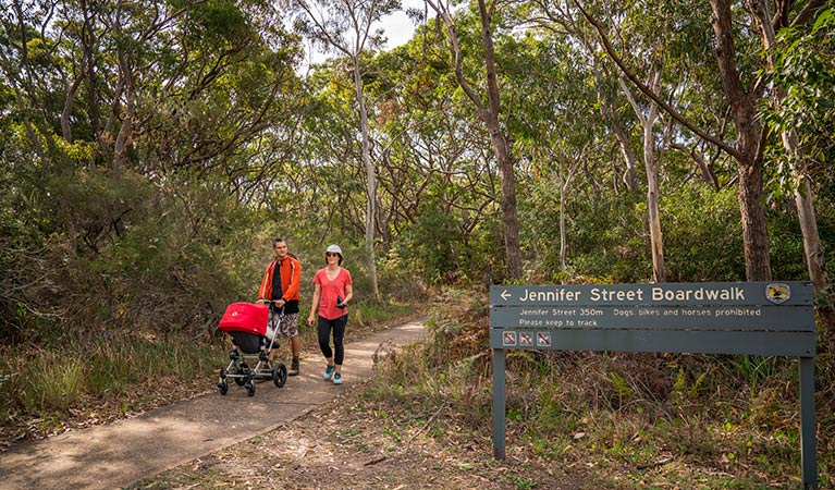  People walking and pushing their pram along the Jennifer Street boardwalk, La Perouse area, Kamay Botany Bay National Park. Photo: John Spencer &copy; OEH