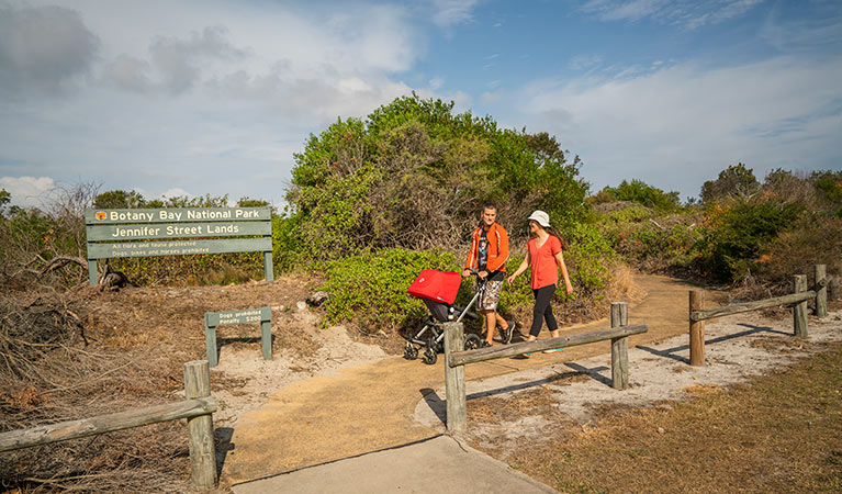 People walking and pushing their pram along the Jennifer Street boardwalk, La Perouse area, Kamay Botany Bay National Park. Photo: John Spencer &copy; OEH