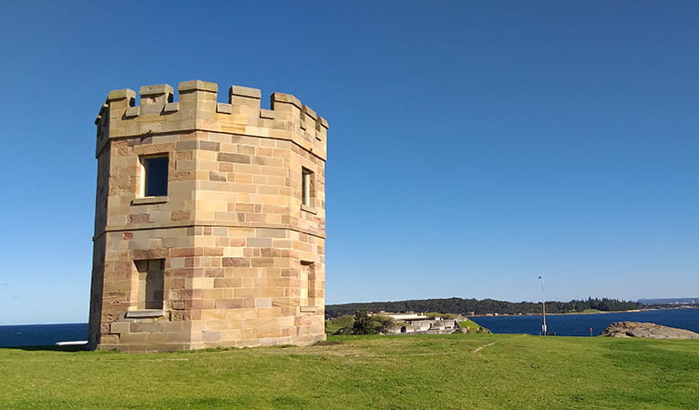 Watchtower of stone masonry on a grass lawn in the La Perouse area of Kamay Botany Bay National Park. Photo: Stacy Wilson/DPIE