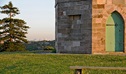 Detail of stone masonry and doorway of Macquarie watchtower, set on a grass lawn, with a pine tree in the background. Photo: Kevin McGrath/DPIE