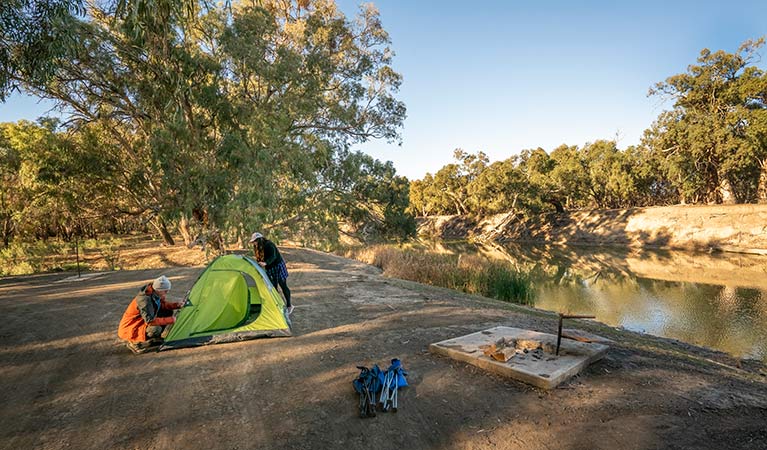 2 campers setting up their tent at Darling River campground. Photo: John Spencer/DPIE