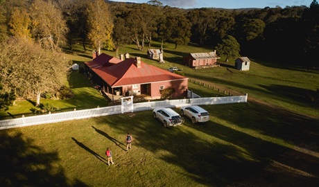 A bird's eye view of a couple walking towards Currango Homestead, Kosciuszko National Park. Photo: Rob Mulally/DPIE