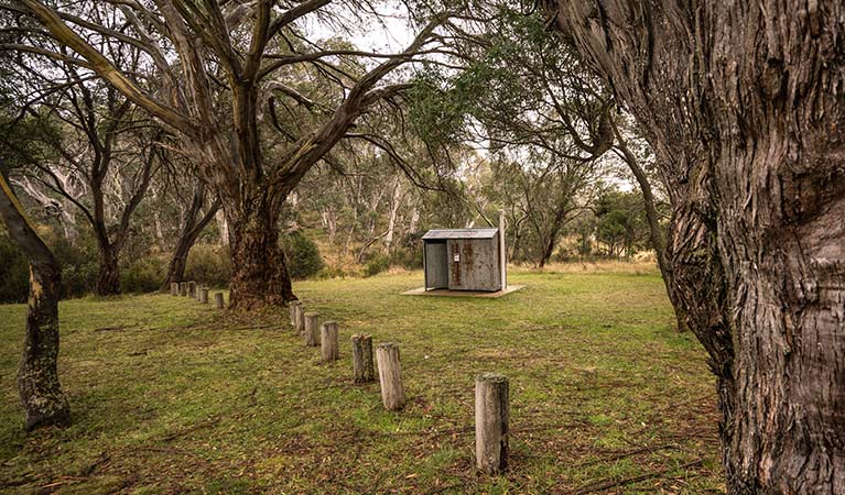 Non-flush toilet tin building among trees, Long Plain Hut campground, Kosciuszko National Park. Photo: Robert Mulally/OEH