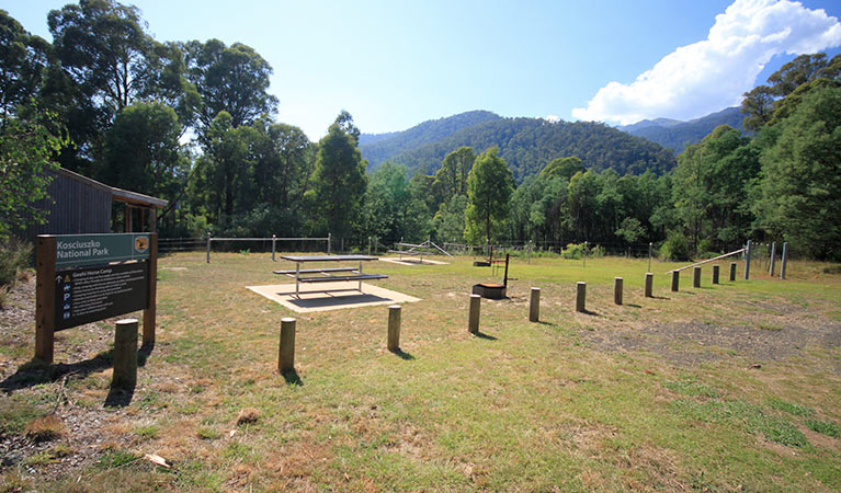 Sign and facilities at Geehi horse camp, with views of forested mountains in Kosciuszko National Park. Photo: Elinor Sheargold &copy; DPIE