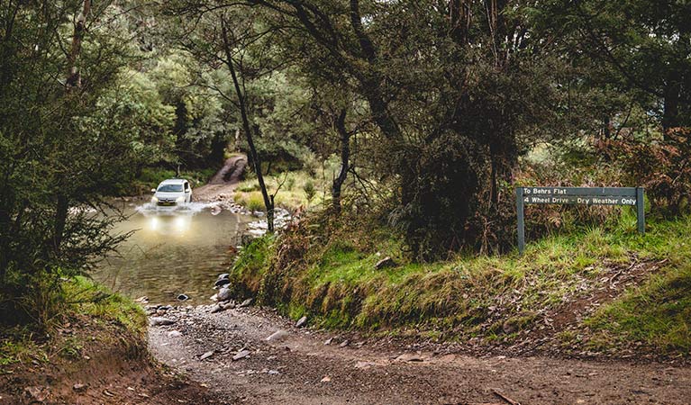 A white 4WD vehicle crosses the Swampy Plain River, near Geehi Flats, Kosciuszko National Park. Photo &copy; Robert Mulally