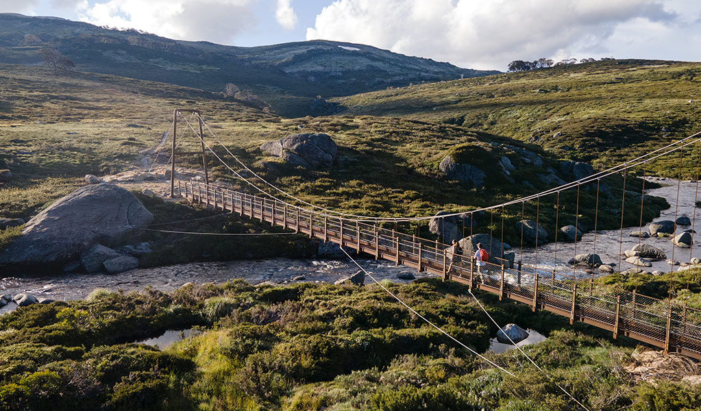 An aerial view of Spencers Creek Bridge along Guthega to Charlottes Pass walk in Kosciuszko National Park. Credit: Boen Ferguson &copy; DCCEEW