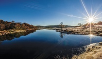 The sun dips on the horizon at Three Mile Dam, central Kosciuszko National Park. Photo: Murray Vanderveer/DPIE