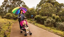 A woman with a pram walks Bundilla accessible track, Kosciuszko National Park. Photo: Murray Vanderveer &copy; DPE