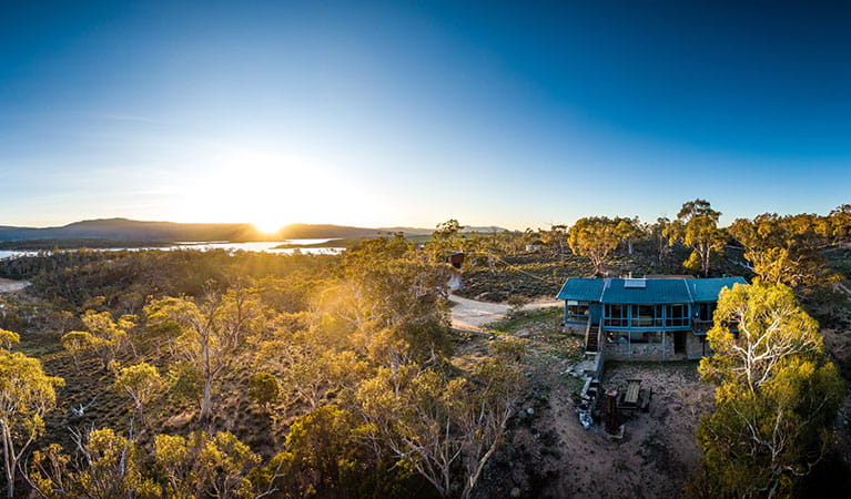 Aerial view of Creel Lodge, surrounded by bushland with Lake Jindabyne to the left and sunrise in the background. Photo: &copy; Murray Vanderveer