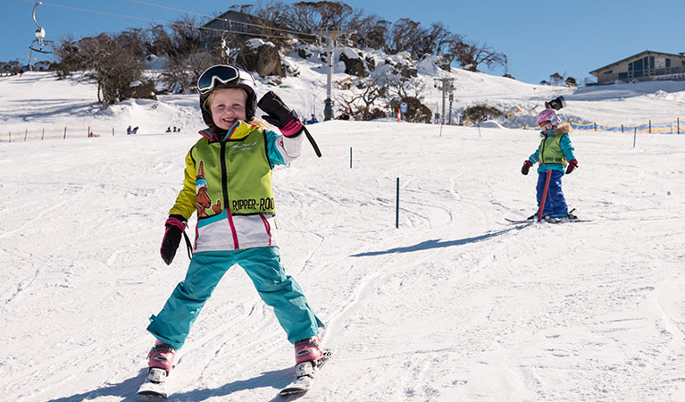 Young children ski down a slope at Perisher Ski Resort in Kosciuszko National Park. Photo: Images supplied courtesy of Perisher Ski Resort