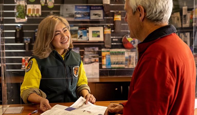 National Parks staff assisting a visitor at Perisher Valley Office, in Kosciuszko National Park. Photo credit: Murray Vanderveer &copy; DPIE