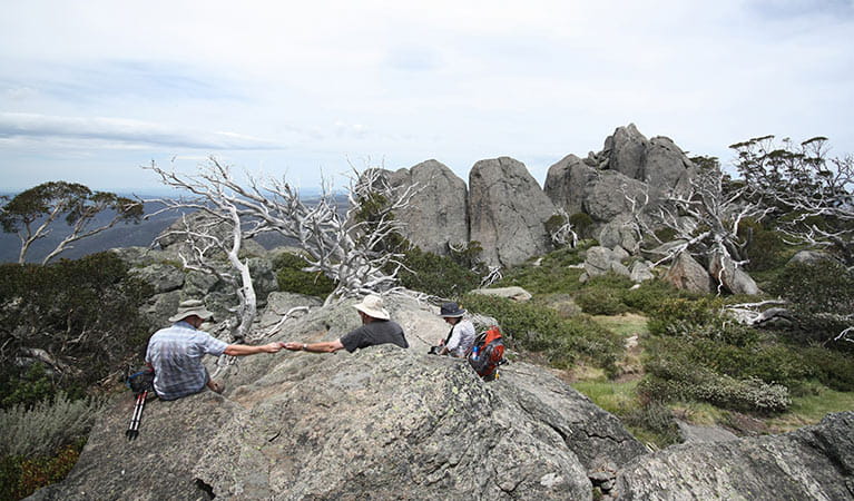A trio of hikers rest at Porcupine Rocks, near Perisher, in Kosciuszko National Park. Photo: Elinor Sheargold &copy; OEH