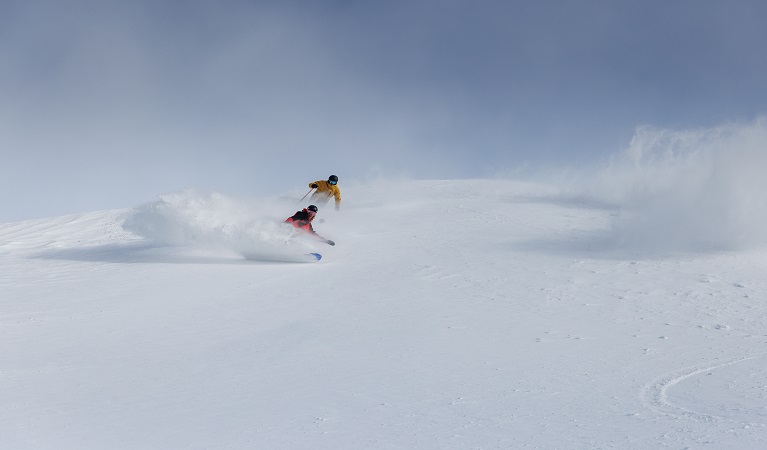 Skiers descending slopes at Thredbo, Kosciuszko National Park. Photo: Thredbo Resort