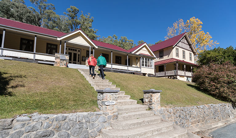 A couple at entry steps to Yarrangobilly Caves House East and West wings, Kosciuszko National Park. Photo: Boen Ferguson/OEH