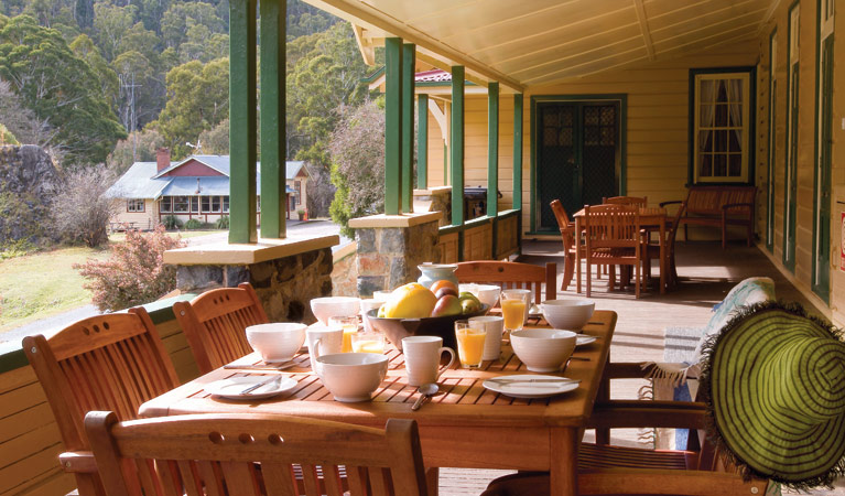 Breakfast on the verandah at Yarrangobilly Caves House 1901 section, Kosciuszko National Park. Photo: Michael van Ewijk/OEH.