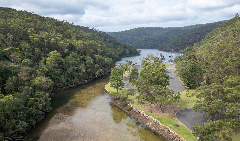 An aerial photo of Apple Tree picnic area surrounded by Apple Tree Creek, Cowan Creek and Ku-ring-gai Chase National Park bushland. Credit: John Spencer &copy; DCCEEW