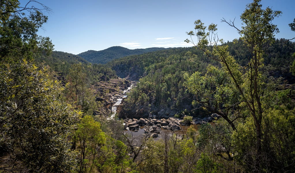The view over the river, which is bordered by rocks and thick trees, with mountains in the distance, Junction walk, Kwiambal National Park. Photo: DPE &copy; DPE