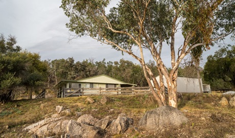 The exterior of Lavender Vale Cottage surrounded by trees in Kwiambal National Park. Photo &copy; DPE