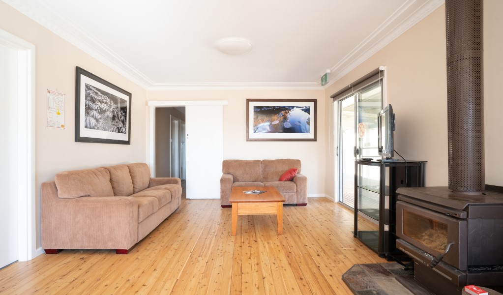 The lounge room with couches and fireplace in Lavender Vale Cottage, Kwiambal National Park. Photo &copy; DPE