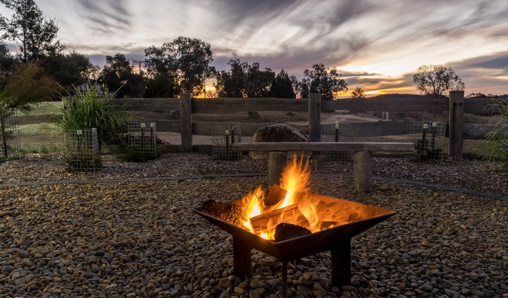 A lit firepit against the backdrop of Kwiambal National Park at Lavender Vale Cottage. Photo &copy; DPE